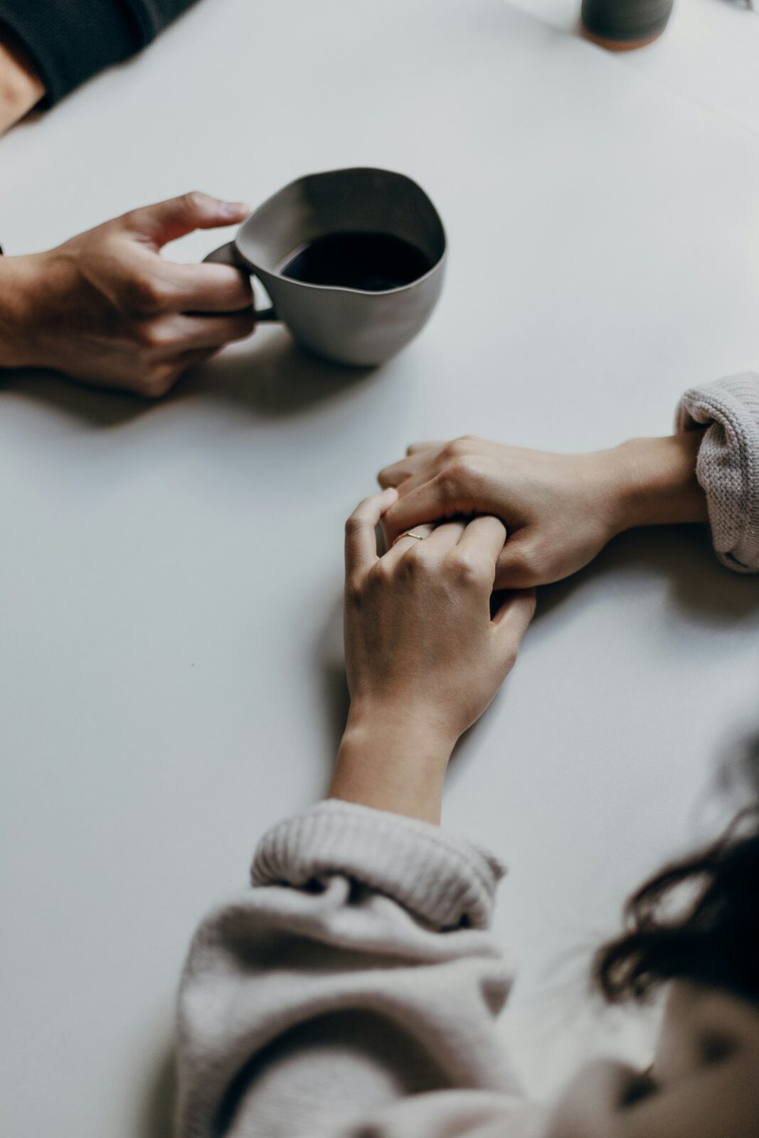 Two hands holding each other