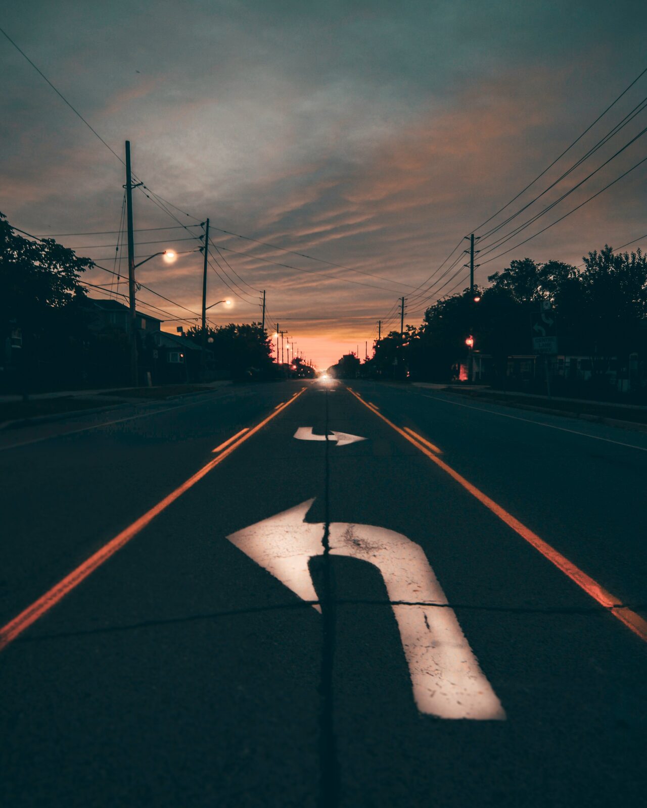A quiet street at dusk with street lamps
